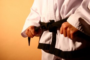 become a black-belt in a form of martial arts.